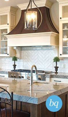 a large kitchen with an island in the middle and two chairs at the counter top