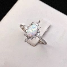 White Fire Opal Sterling Silver Ring, Cabochon Opal Ring, Fire Opal Engagement Ring, White Opal, Minimalistic Ring, Stacking Ring, Promise Ring 💎 Gemstone: Conflict-free Cabochon Fire-Opal (Origin Mexico) 💎 Base Material: Solid Sterling Silver (925) 💎 Additional Material: Rhodium (Precious Metal) 💎 Stamps / Markings: 925 After-Sale Services: 💎 30 Days No Quibble Return or Exchange 💎 Guarantee: 90 Days Free Repairing ( Free Exchange if necessary) 💎 Warranty: Lifetime Free Polishing and Cle Silver Opal Ring With Halo Design, Silver Opal Ring With Halo Design Fine Jewelry, Silver Opal Rings With Center Stone, White Opal Ring With Cubic Zirconia As Gift, White Opal Cubic Zirconia Promise Ring, Silver Opal Ring With Halo Design For Formal Occasions, White Opal Ring With Cubic Zirconia, Formal Silver Opal Ring With Halo, Formal Silver Opal Ring With Halo Design