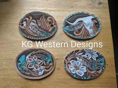 four coasters with designs on them sitting on a table