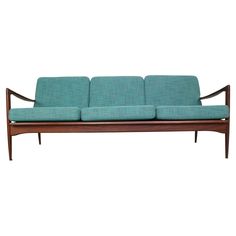 a blue couch sitting on top of a wooden frame