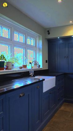 a kitchen with blue cabinets and counter tops