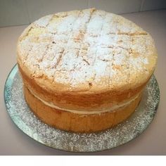 a cake sitting on top of a plate covered in powdered sugar