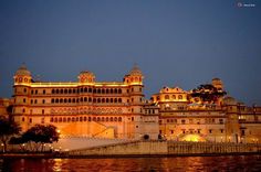 the palace is lit up at night with its lights on