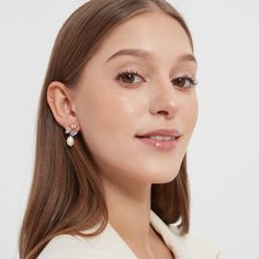 Experience an irresistible combination of glam and femininity with these Cecilia Fresh Water Pearl Earrings. Crafted with high quality fresh water pearls and three heart shape cubic zirconia set in a 18K gold plating, these earrings will take your look to the next level. Delicate yet detailed, these fashion-forward earrings will add a hint of classic elegance to any look! To keep your jewellery in the best condition, we recommend giving it a good care over time. By using a soft, lint-free jewellery cloth, you can remove blemishes that result from body oils, perfumes and lotions. Also remember try not to expose your jewellery in the open air. Our branded dusty bag or your jewellery box will keep them last longer. If you go to gym or spa, remember to take them off, because water or sweat wil Fresh Water Pearl Earrings, Luxury Delicate Akoya Pearl Earrings, Elegant Pearl Embellished Cubic Zirconia Earrings, Delicate Akoya Pearl Earrings With Pearl Charm, Go To Gym, Pearl-embellished Cubic Zirconia Drop Earrings, Body Oils, Pearl Design, Fresh Water Pearls