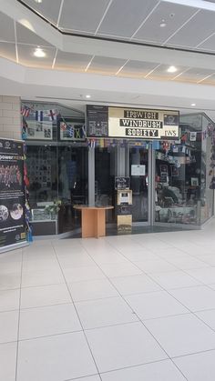 the inside of a store with signs and posters on the front wall, along with other items