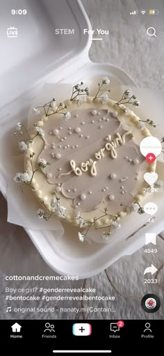 the cake is decorated with white flowers and pearls on it's side, surrounded by bubbles