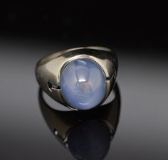 This is a Men's 20K White Gold Star Sapphire High Dome Cabochon, Lavender shade, approximately 10 carat stone, Circa 1960's, Ring size 9, Weight 14.4 grams. Stock # BB68R01 Gold Claddagh Ring, Star Sapphire, Men's Jewelry Rings, Fine Jewelry Designers, Gold Star, Size 10 Rings, Blue Topaz Ring, Topaz Ring, Gold Stars