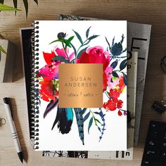 an open notebook sitting on top of a wooden table