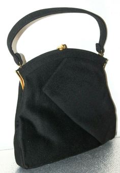 Vintage 1960's  Sydney of California  Black Cloth Evening -  Formal Handbag w/Strap Excellent, clean condition. Formal fabric wrap look on  both sides. Measures 9.75" from bottom of purse to top of gold clasp. 9.5" across the base. Hangs about 14" with strap. The strap is not removable. Fleece type exterior material. Clean satin type interior with 4 slotted side pockets. White pocket double sided mirror included. Mirror has the spinning wheel logo.  Strap hardware intact.  Closure secure.  Very