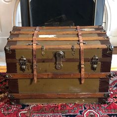 an old trunk sitting on top of a rug