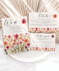 the wedding stationery is laid out on a white plate with pink and orange flowers