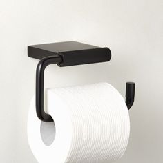 a black toilet paper holder on a white wall