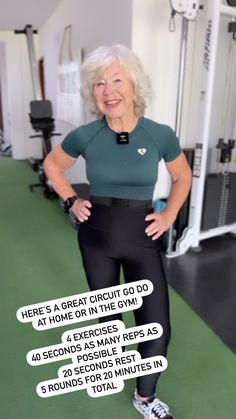 an older woman standing in front of a gym machine with her hands on her hips