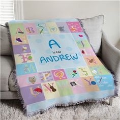 a child's blanket with the words a is for andrew on it sitting on a chair