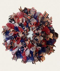 a patriotic wreath with red, white and blue ribbons