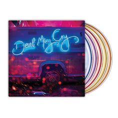 an album cover with neon lights in the background and a van parked on the street