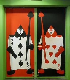 two doors decorated with playing cards and spades