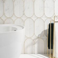 a white sink sitting next to a wall mounted faucet