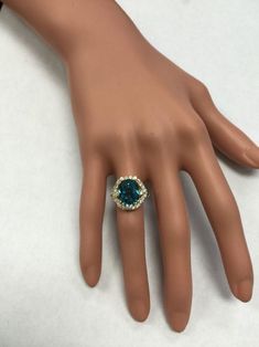 8.70 Carats Natural Very Nice Looking Blue Zircon and Diamond 14K Yellow Gold Ring Suggested Replacement Value: 9,000.00 Total Natural Cushion Shaped Zircon Weights: Approx. 7.80 Carats Zircon Measures: 11 x 8.4mm Natural Round Diamonds Weight: .90 Carats (color G-H / Clarity SI1-SI2) Ring total weight: 5.2 grams Disclaimer: all weights, measurements and colors are approximate and may vary slightly from the listed dimensions or as seen in the image. All pictures are magnified to show the smalles Luxury Blue Sapphire Ring With 17 Jewels, Luxury Blue Gemstone Cluster Ring, Formal Blue Topaz Ring With Diamond, Luxury Blue Ring With Diamond Accents, Formal Sapphire Topaz Ring With Diamond Accents, Luxury Formal Blue Diamond Ring, Formal Turquoise Jewelry With Halo Setting, Blue Emerald Ring For Formal Occasions, Blue Emerald Gemstone Ring