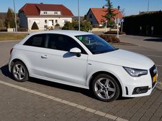 a white car parked in a parking lot