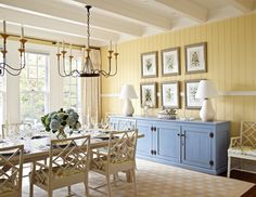 a dining room with blue cabinets and pictures on the wall