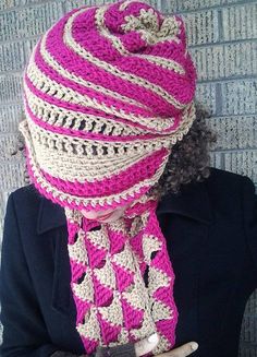 a woman wearing a pink and white crocheted hat with a scarf around her neck