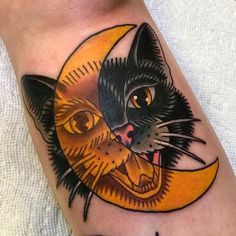 a black cat with a crescent moon tattoo on his arm