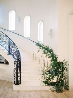 an elegant staircase decorated with flowers and candles