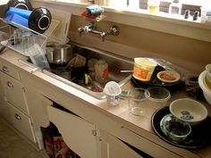 the kitchen sink is full of dirty dishes