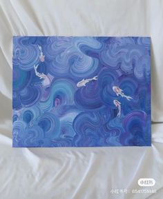 two koi fish are swimming in the blue and purple swirls on this card