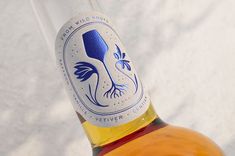 a bottle of wine sitting on top of a white tablecloth covered floor next to a wall