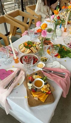 a table set with food and flowers on it for a wedding or bridal party