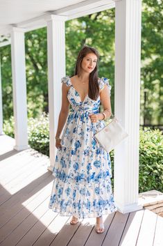 White and blue floral satin layer tiered maxi dress with lace up open back Show off your elegant side in this Satin Florals Blue Maxi Dress! White satin fabric with blue floral print, featuring a v neckline with ruffled spaghetti straps, an open back with lace up detail, and tiered layers. Figuring flattering, and stunning! Perfect for any special occasion! True to size fit Model is 5'5" wearing a small Fabric does contain slight stretch Deep v neckline with ruched bodice Sleeveless with ruffled Blue Fitted Maxi Dress With Ruffled Straps, Elegant Blue Maxi Dress With Ruffled Straps, Blue Maxi Dress With Ruffled Straps For Vacation, Blue Maxi Dress With Ruffled Straps For Garden Party, Chic Blue Maxi Dress With Ruffled Straps, Blue Tiered Maxi Dress For Garden Party, Chinoiserie Dress, White Satin Fabric, Chinese Fancy Dress