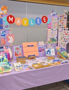 a purple table topped with lots of cards and magnets on it's sides