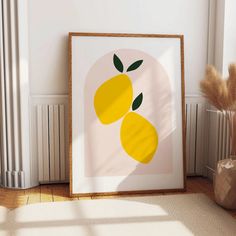 a framed art print with two lemons on it in front of a radiator