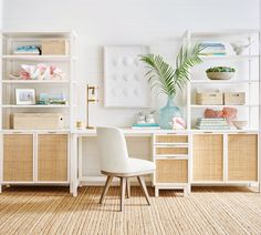 a white chair sitting in front of a desk with bookshelves and baskets on it