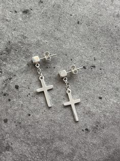 "These sterling silver dangling cross earrings feature 3D Cube post. They have a clean and edgy style that would work for men or women. The cube earring post is 4 mm and it is a perfect size to really make a statement, but not to go overboard. Chain style creates a lot of movement. The cross is on the thicker side to create a balance with the cube post. The earrings are made entirely of sterling silver and have a smooth clean finish, shiny but not too polished. You can choose to buy 1 earring or Minimalist Cross Pendant Earrings, Silver Cross Pendant Earrings, Silver Hypoallergenic Cross Earrings, Hypoallergenic Silver Cross Earrings, Minimalist Silver Cross Earrings, Mens Dangle Earrings, Dangle Cross Earrings, Earrings Mens, Mens Earrings