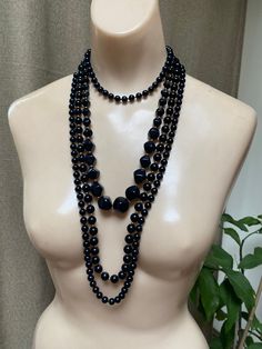 "Some ladies like only pearls. Others like bright colored pieces of jewelry. And you might be the lady who, like me, likes black jewelry. For that reason I have compiled 3 black and gold bead necklace with a pair of black and gold clip on earrings to wear together or in any arrangement you might like. Especially nice for the lady who wears lots of black and white clothing and is always looking for jewelry to go with. The longest necklace doesn't have any gold beads. Spring ring clasp. Knotted be Black Beaded Necklace For Formal Costume Jewelry, Black Beaded Costume Jewelry Necklace For Formal Occasions, Formal Black Beaded Costume Jewelry Necklace, Formal Black Beaded Costume Necklace, Black Round Beads Costume Jewelry Necklace, Black Round Beaded Costume Jewelry Necklace, Black Beaded Necklace Costume Jewelry, Black Beaded Necklaces Costume Jewelry, Formal Black Necklaces With Black Beads