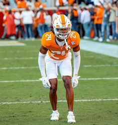 an orange and white football player on the field