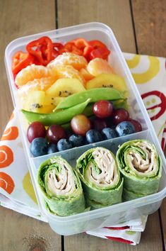 a plastic container filled with fruit and veggies