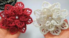 two small crocheted flowers are held in their hands