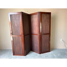 an open wooden cabinet sitting on top of a floor