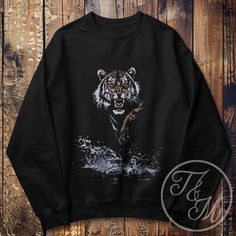 + Ideal for any situation, a unisex heavy blend crewneck sweatshirt is pure comfort. These garments are made from polyester and cotton. This combination helps designs come out looking fresh and beautiful. This crewneck sweatshirt features a vintage style Y2K inspired graphic design of the majestic and mighty Tiger. This sweatshirt is a perfect gift for anyone who enjoys the outdoors and Tigers. + We recommend ordering a size up for an oversized fit. (ex: If you wear a size L; order an XL) 🚚 Fre Black Cotton Sweatshirt With Sublimation Print, Black Sweatshirt With Sublimation Print For Streetwear, Black Long Sleeve Sweatshirt With Sublimation Print, Tiger Sweater, Tiger Vintage, Tiger Gifts, One Drop, Sew-in Labels, Tigers