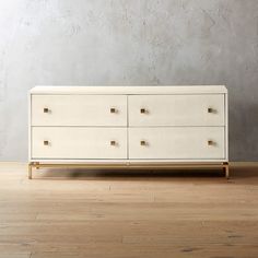 a white dresser sitting on top of a hard wood floor