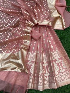 It's a beautiful lehenga set of chanderi material . The whole collection has beautiful pastel and few bright shades .  Lehenga - 5 Mtr Banarasi Matt zari lorex fabric. Blouse - 1 mtr lorex matt zari Dupatta - 2.5 mtr matt lorex fancy weaving  Dry clean only . Please note - color may be vary a little due to sunlight and photography . This is unstitched material only . Lehenga and blouse stitching is also available . Festive Pink Cotton Silk Sharara, Designer Cotton Silk Choli With Gota Work, Pink Cotton Silk Sharara For Diwali, Pink Cotton Silk Dupatta With Gota Work, Pink Cotton Silk Sets With Gota Work, Lehenga With Sheer Dupatta In Cotton Silk, Festive Tissue Silk Set With Cutdana Work, Festive Tissue Silk Set With Cutdana, Unstitched Anarkali Cotton Silk Lehenga