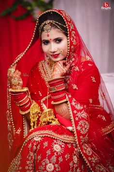 a woman dressed in red and gold poses for the camera