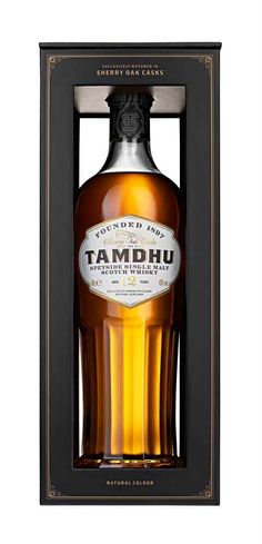 a bottle of tamdhu is in a black box with gold trimmings