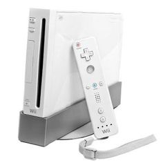 a nintendo wii game system sitting on top of a white table next to a controller