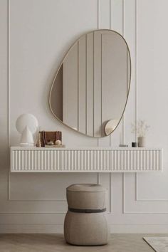 a white table with a round mirror on it