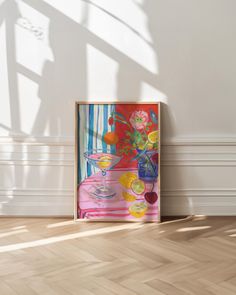 a painting on the wall next to a wooden floor with a vase filled with flowers and fruit